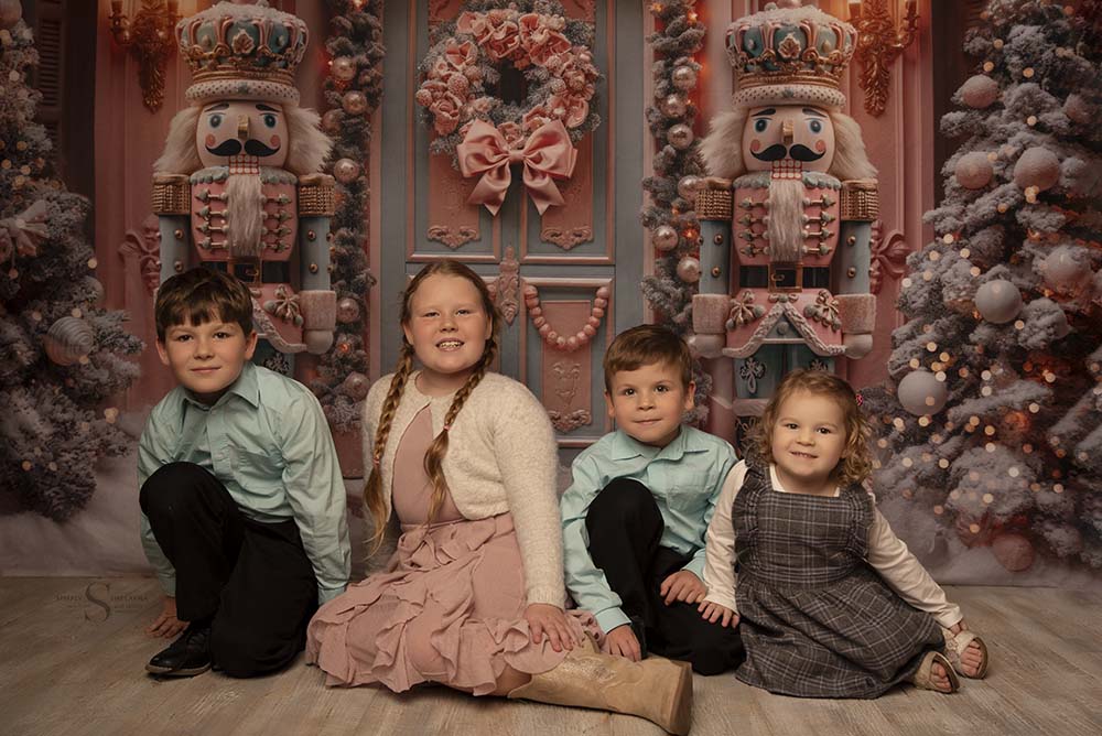 Four siblings pose for a Christmas portrait with Simply Shelayna Family Photography in Syracuse NY.