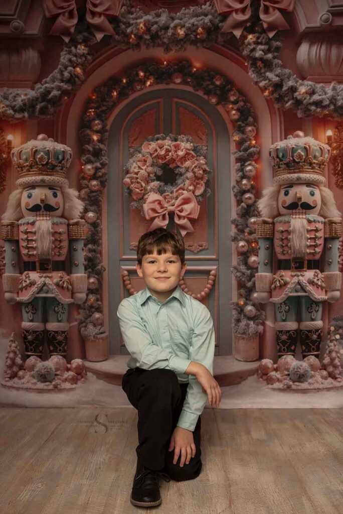 A young boy poses in a Christmas setting with Simply Shelayna Family Photographer in Syracuse NY.