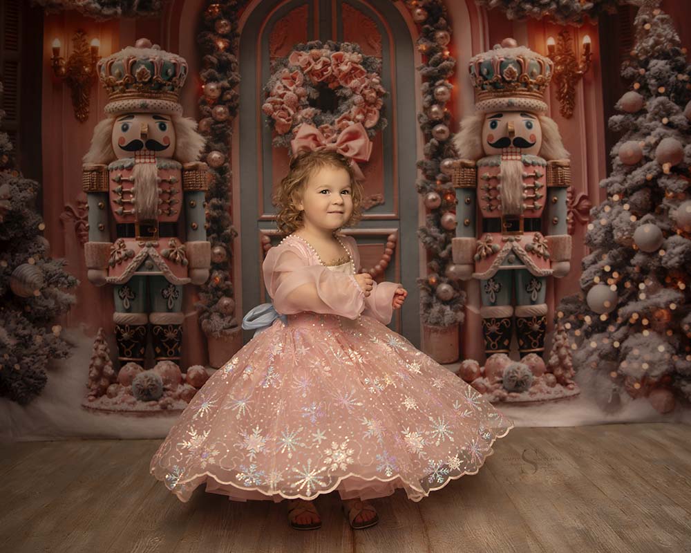 A toddler girl dances and poses in a full pink Nutcracker gown for Christmas pictures with Simply Shelayna in Oswego NY.