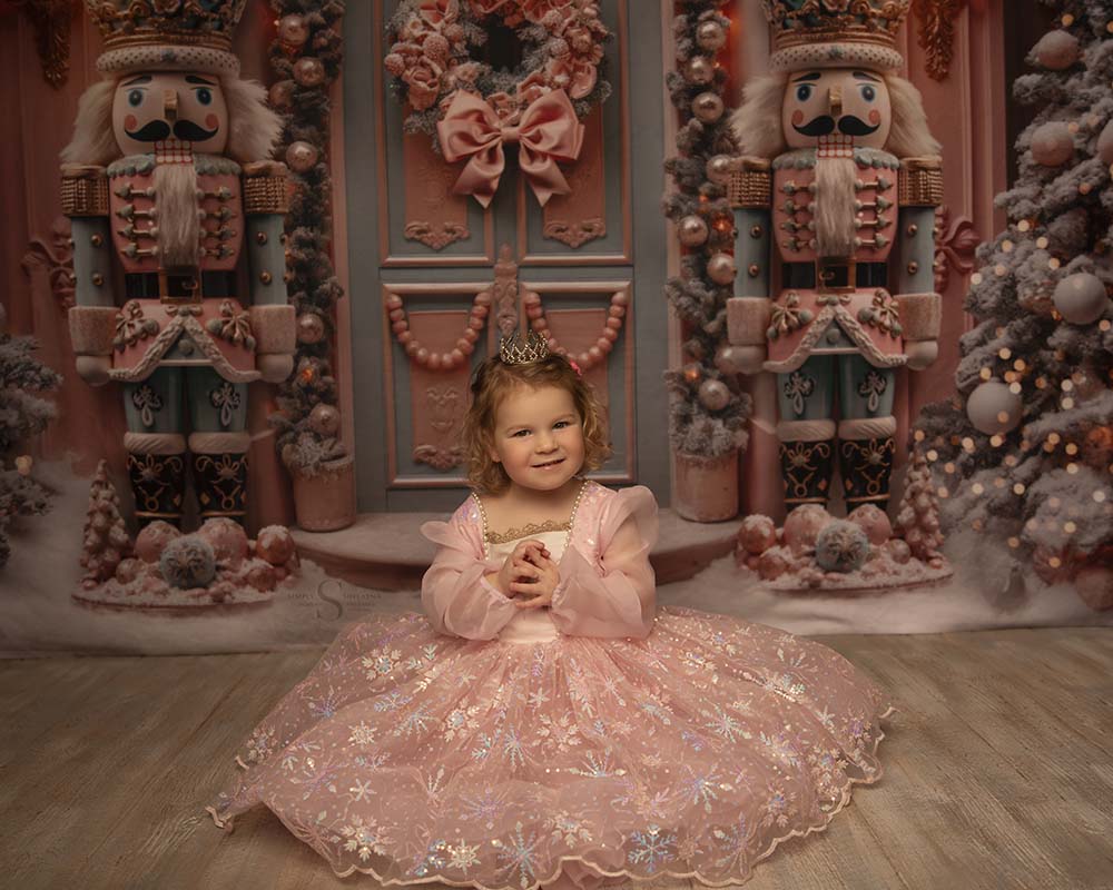A toddler girl dances and poses in a full pink Nutcracker gown for Christmas pictures with Simply Shelayna in Oswego NY.
