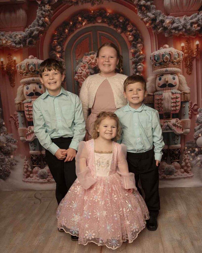 Four siblings pose for a Christmas portrait with Simply Shelayna Family Photography in Syracuse NY.