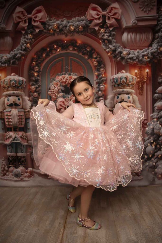 A young girl in a pink nutcracker dress curtesy with Simply Shelayna Family Photographer in Syracuse NY.