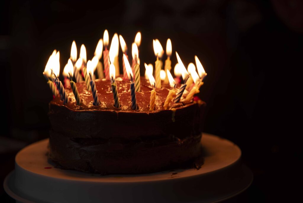 An image of a birthday cake with 40 candles lit on it with Simply Shelayna family photographer in Syracuse NY.