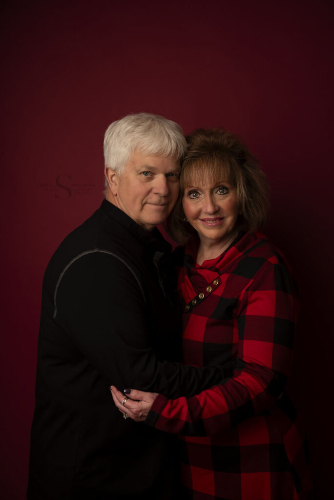 A couple pose for a Christmas portrait with Simply Shelayna Family Photography in Oswego NY.