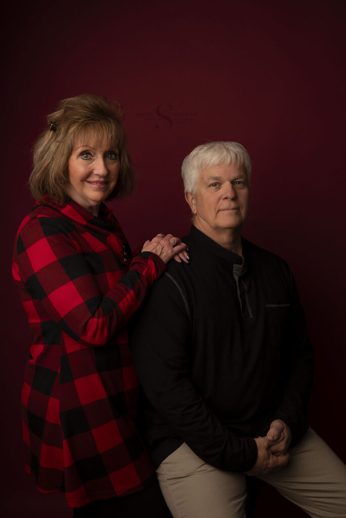 A couple pose for a Christmas portrait with Simply Shelayna Family Photography in Oswego NY.