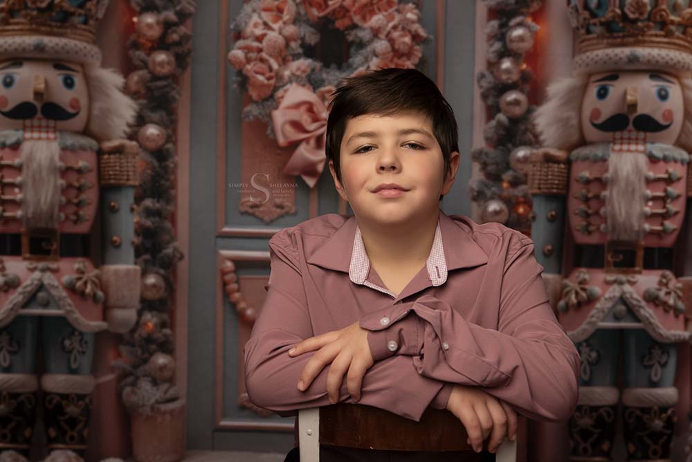 A young boy looks straight on for a portrait with Simply Shelayna Family Photography in Oswego NY.