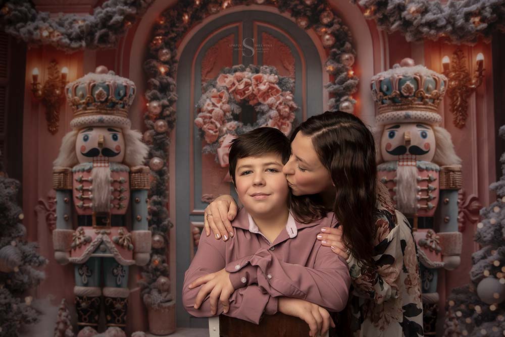 A mother kisses her preteen son in a portrait with Simply Shelayna Christmas Family Portraits in Syracuse NY.