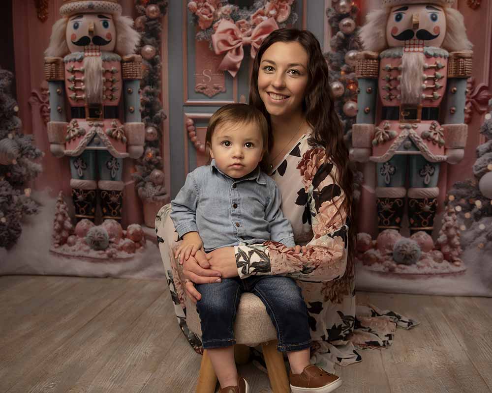 A mother sits close to her toddler son for a Christmas portrait with Simply Shelayna Family Photography in CNY.