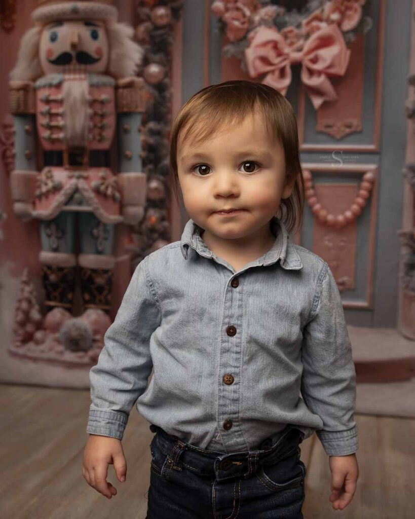A toddler boy poses for a Christmas portrait with Simply Shelayna Photography in Syracuse NY.