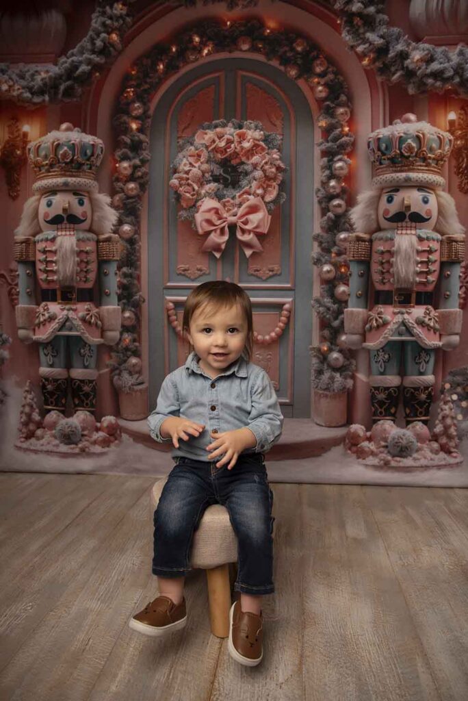 A toddler boy sits on a small stool for a Christmas portrait with Simply Shelayna Photography in Syracuse NY.