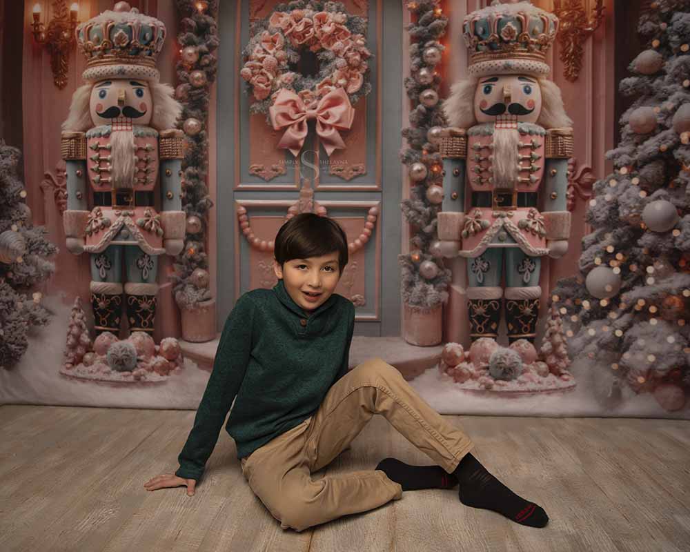 a young boy poses on the floor with his back knee elevated for a Christmas portrait with Simply Shelayna Family Photography in Oswego NY.