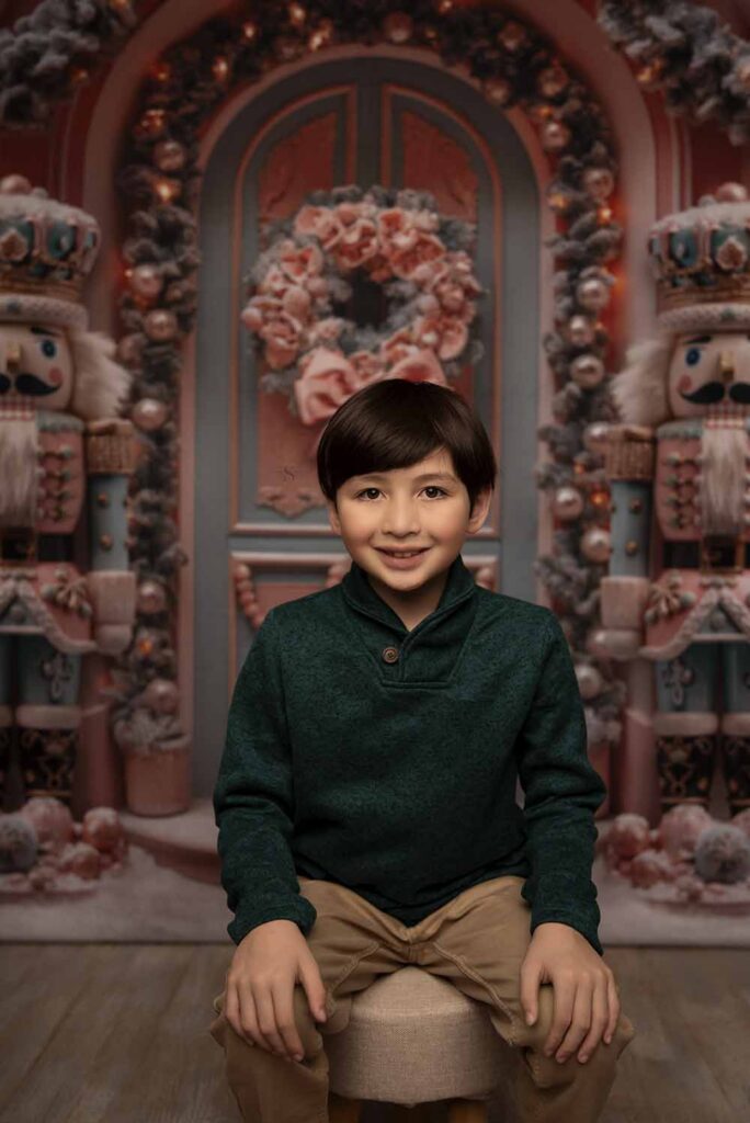 A young boy leans into the camera for a Christmas portrait with Simply Shelayna Photography in Oswego NY.