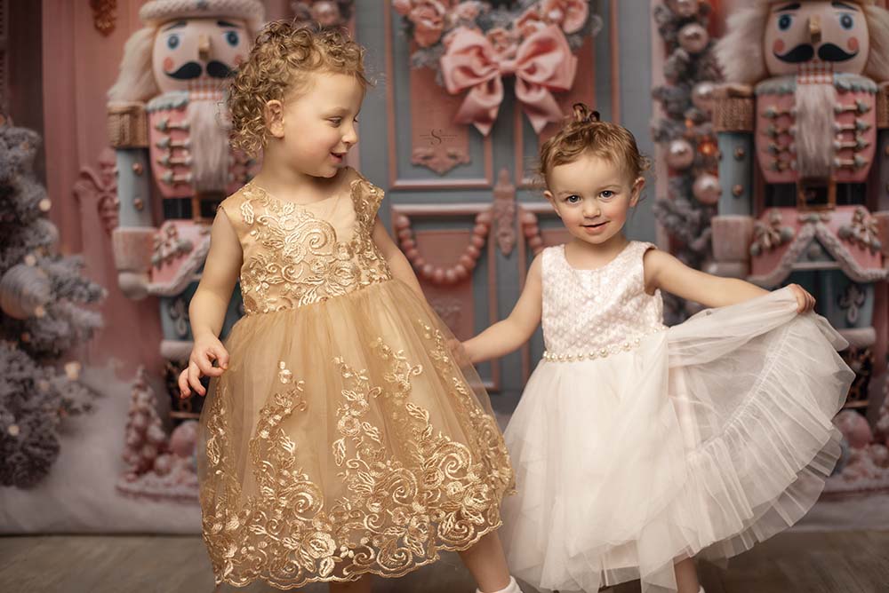 Two sisters pose in Christmas dressed for a portrait with Simply Shelayna Christmas Photography in Albany NY.
