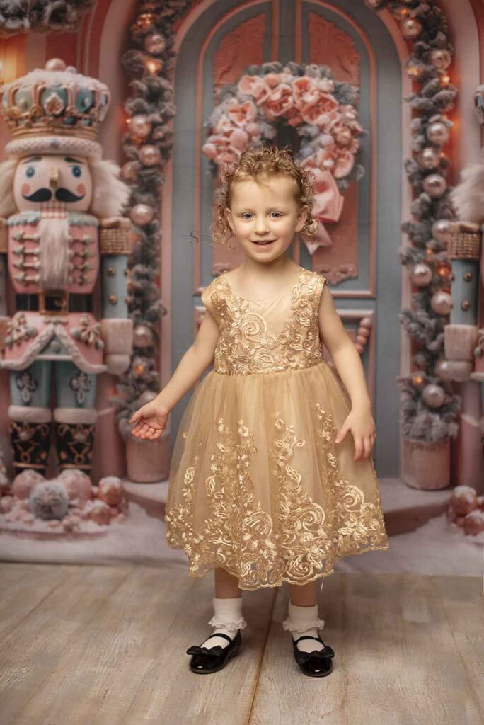 A young girl poses in a gold dress with Simply Shelayna Photography in Albany NY.
