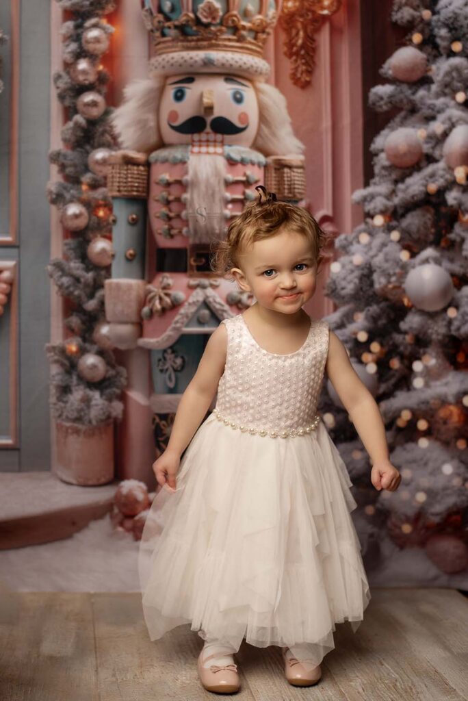 A young girl sheepishly smiles for a portrait with Simply Shelayna photography in Albany NY.