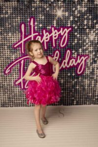 A young girl dressed like Barbie stands for a pose with Simply Shelayna Photography in Syracuse NY.