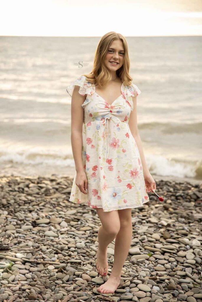 A high school senior poses for a portrait in front of Lake Ontario in Oswego NY with Simply Shelayna Senior Photographer in CNY.