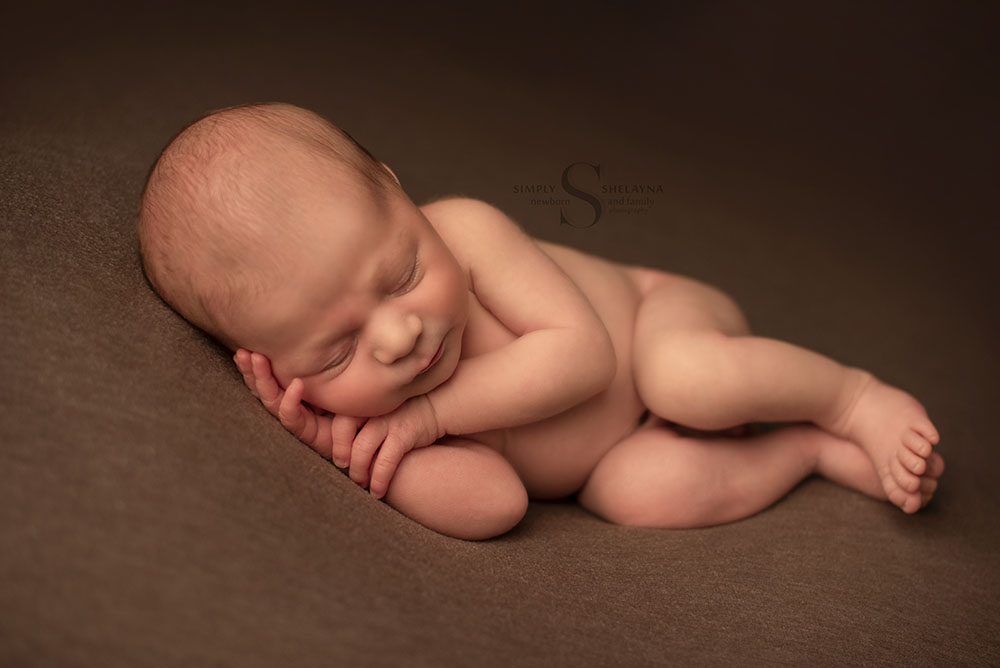 A baby boy sleeps for a portrait with Simply Shelayna Newborn Photography in CNY.