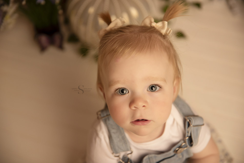 A portrait of a 1 year old girl for her first birthday with Simply Shelayna Baby photography in Syracuse NY.
