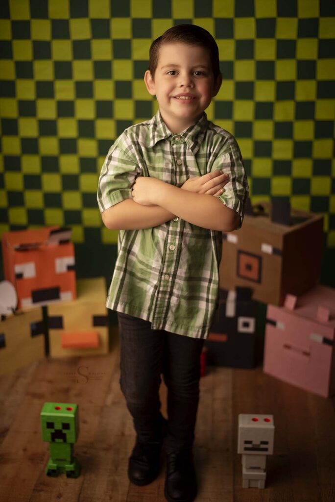 A young boy makes a really silly face for his 5 year old portrait session with Simply Shelayna child photography in CNY.